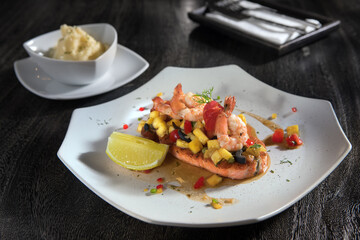 Close up view of salmon steak with shrimps and vegetables