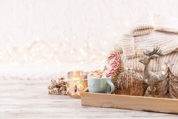 Cup with a hot drink, marshmallow on a table with christmas decorations.