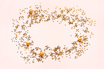 Sparkling gold stars frame on pink background. Magic Christmas confetti golden sparkles. Holiday...