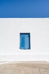 Greek window of a church with blue sky. Cyclades of Greece.