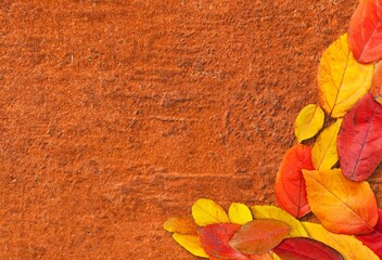 Obraz premium Autumn mood background. Frame made of autumn dried leaves on the desk