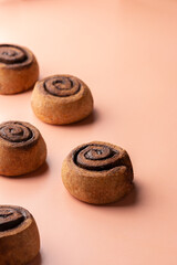 Cinnabon buns with cinnamon copy space. Isolated rolls with chocolate on an orange background.