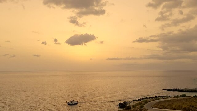 Baia Santa Margherita from sea to torre Isulidda medieval watchtower at sunset. Panning