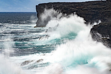 sea in tempest breaking waves on lava rock cliff - obrazy, fototapety, plakaty