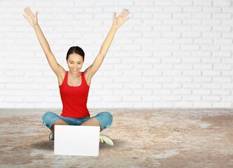 Emotional young woman sitting with laptop, shouting in excitement, winning huge casino bet,