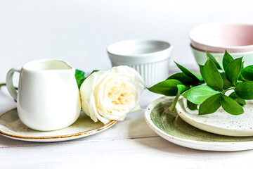 ceramic tableware with flowers on white background