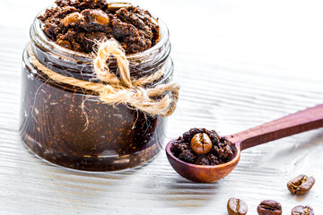 Homemade cosmetics with coffee scrub on white desk background