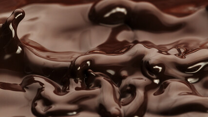 Macro photo of premium dark chocolate splashing.