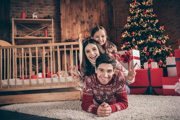 Photo of nice family mom dad daughter new born son show v-sign wear red sweater on christmas day in...