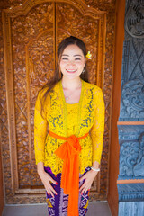happy asian girl wearing balinese female costume