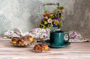 Three cakes on a saucer and a cup of tea close-up