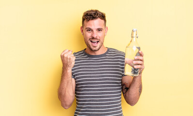 young handsome man shouting aggressively with an angry expression. water concept