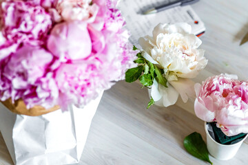 Bouquet of peonies in kraft paper bag
