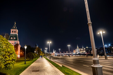 night landscape of the city with illuminated old houses, churches and a fortress wall 