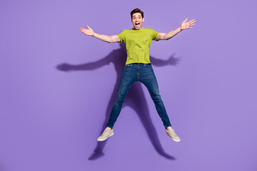 Full length body size view of attractive cheerful kind guy jumping good mood isolated over vivid violet purple color background