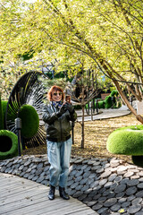 Fototapeta premium woman in children's amusement park on Sunday afternoon in early autumn 