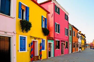 Europe. Italy. Veneto. Burano. The colorful houses of the village of Burano and the leaning tower.