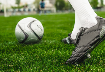 Soccer player with ball on a playing field
