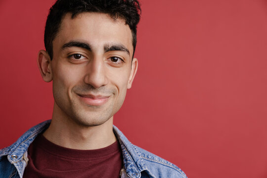 Young middle eastern man smiling and looking at camera