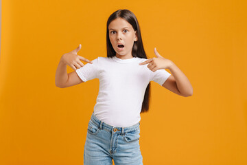 White brunette girl expressing surprise while pointing finger at herself