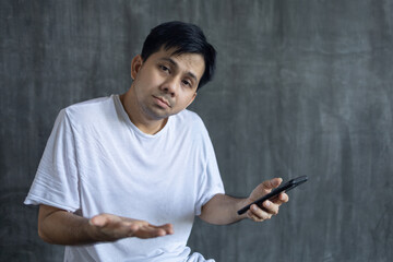 what happened, Asian man looking at smartphone in a bad mood technological intelligence internet outage