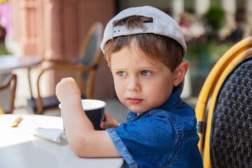 Little kid eating an ice-cream in a face in Wroclaw, Poland