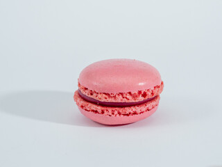 Sweet raspberries macarons isolated on white background.