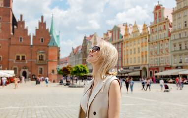 Tourist woman in sunglasses on vacation in old town of Wroclaw, Poland