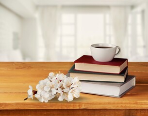 Spring morning coffee. A cup of coffee, open book on a wooden table