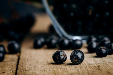 Chokeberry (Aronia melanocarpic) on a wooden table.