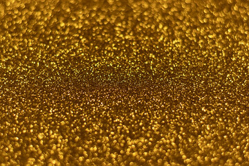 Golden sparkling glitter bokeh background, christmas abstract defocused texture. Holiday lights