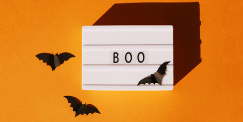 Boo text with flying bats flat lay. Halloween banner 