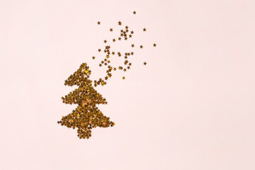 Christmas Tree made of golden stars on pink background. Greeting card with copy space. Magic Christmas and Happy New Year holiday