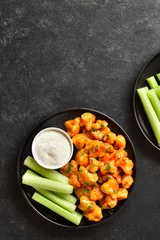 Foto op Canvas Cauliflower buffalo wings with celery and sauce © voltan