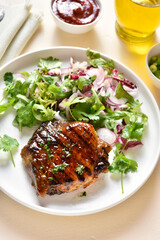 Grilled pork steak with salad from fresh vegetable