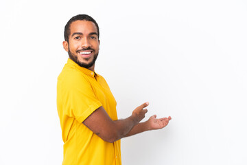 Young Ecuadorian man isolated on white background extending hands to the side for inviting to come