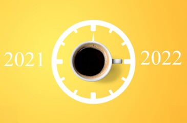 Happy new year 2022. Cup of coffee change 2021 to 2022 on the background. Start concept