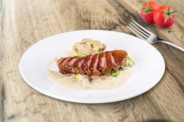 Tasty fish dish in a bowl, fork on a wooden table. Low calories healthy eating