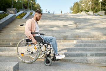 Alone man in wheelchair at the stairs, disability