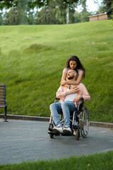 Love couple with wheelchair walking in autumn park