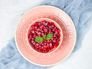 Frozen red currants in a plate.