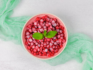 Frozen red currants in a plate.