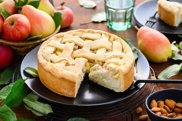Pear pie with custard almond cream on a wooden table.  Autumn bakery. Selective focus. 