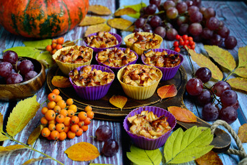 Appetizing apple muffins on an autumn background.