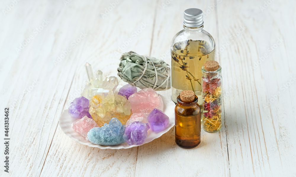 Wall mural minerals, sage bundle and magic bottles on on white wooden background. Wiccan Witchcraft. esoteric spiritual practice for aura cleansing, relax, self care