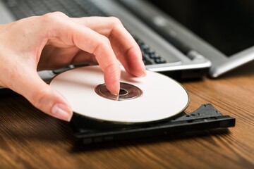 Hand Inserting CD , DVD in Laptop