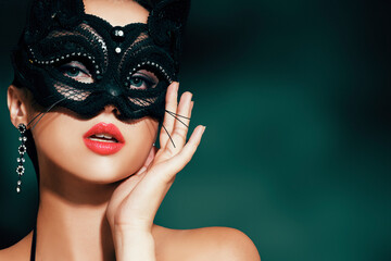 The girl in the mask. Masquerade, halloween. Girl in a cat mask. Catwoman on a beautiful background in a beautiful lace top with long earrings . - obrazy, fototapety, plakaty