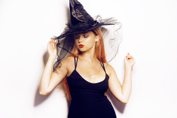 Beautiful girl witch in shock celebrates halloween fashion photo