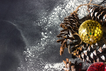 Christmas ornament background from toys, cones, snow, mirror balls, copy space