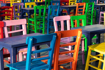 Fototapeta na wymiar Multicolored wooden tables and chairs. Full frame background.